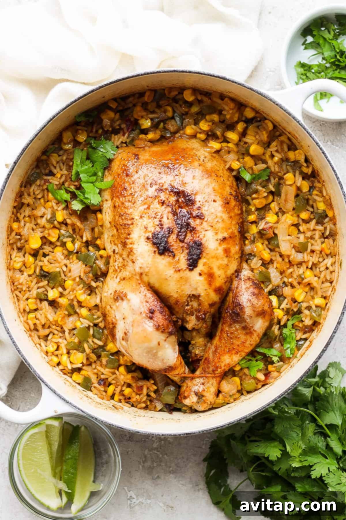 A delicious skillet of whole roasted chicken with Spanish rice and corn, ready to be served.