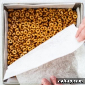 A person putting pretzels in a baking pan.