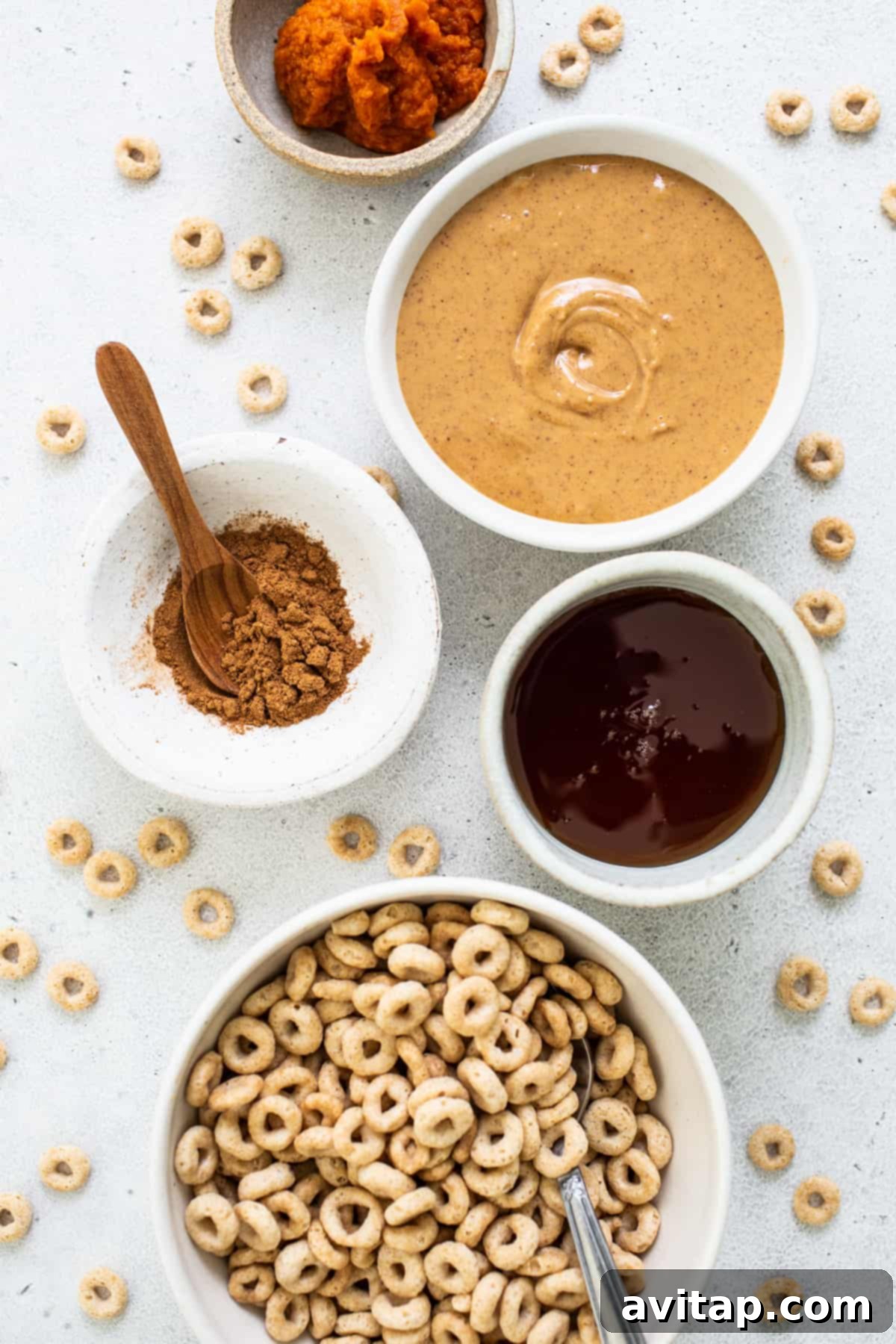 Pumpkin Spice Peanut Butter Crunch Bars 3 A bowl of cereal, a bowl of peanut butter, a bowl of oatmeal, and a bowl of granola.
