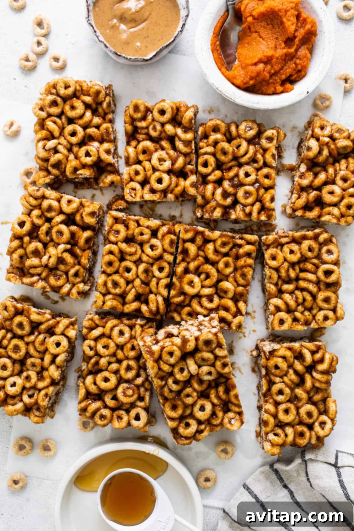 Pumpkin Spice Peanut Butter Crunch Bars 7 A plate of granola bars with a bowl of peanut butter.