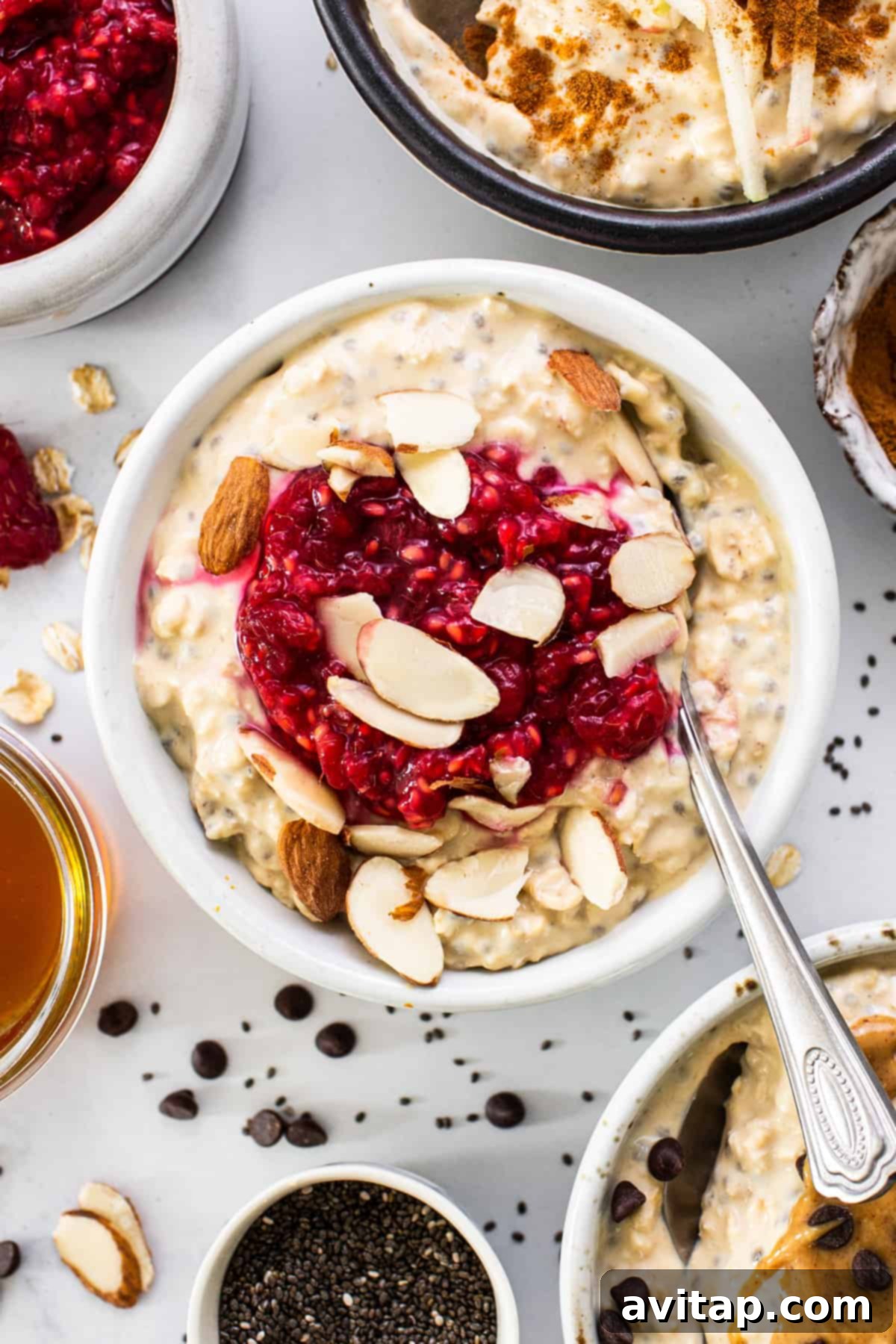 Protein Overnight Oats Three Delicious Varieties 2 A vibrant bowl of protein overnight oats, generously topped with fresh berries, sliced nuts, and a drizzle of honey, set against a bright, inviting background.