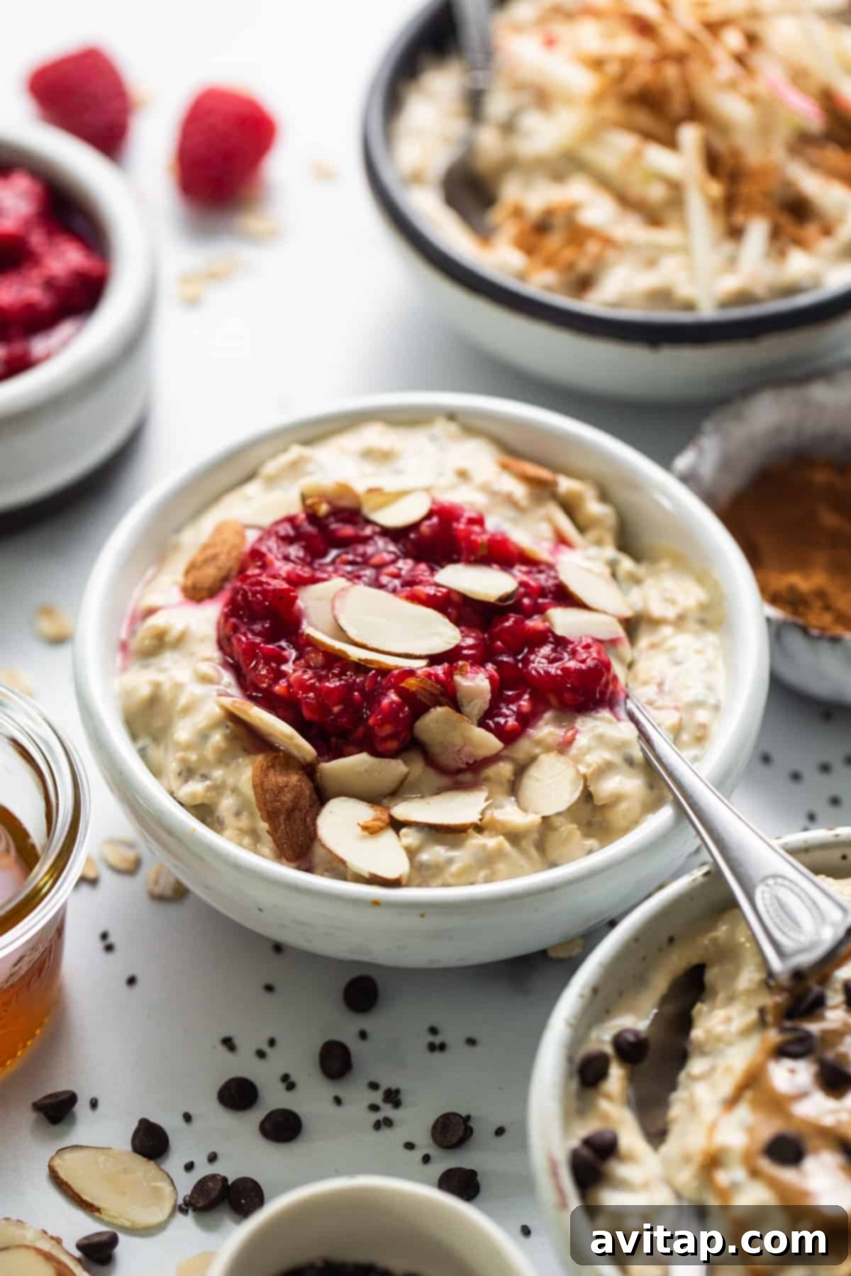 Protein Overnight Oats Three Delicious Varieties 10 A beautifully composed bowl of oatmeal, artfully garnished with fresh raspberries and slivered almonds, ready for a healthy and satisfying meal.