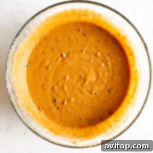 A bowl with pumpkin muffin batter, ready for the next step.