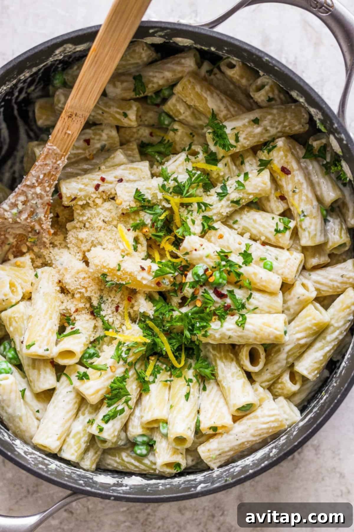 Creamy One-Pot Boursin Pasta 2 Penne pasta in a pan with parmesan cheese and parsley, ready to be served.