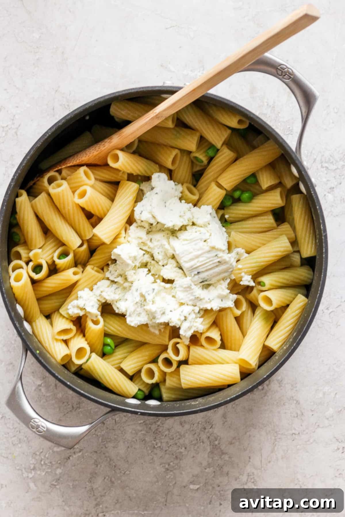 Creamy One-Pot Boursin Pasta 6 Penne pasta with peas and feta cheese in a skillet, showcasing the completed dish.
