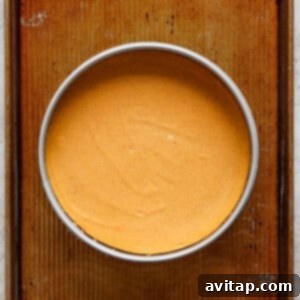 A bowl of pumpkin pie on a baking sheet.