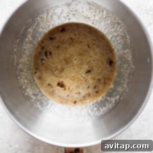 A metal pan with brown liquid in it.