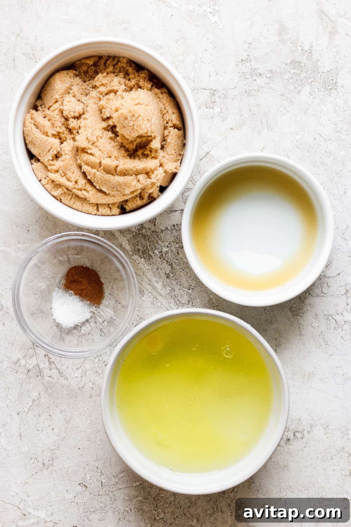 A glass bowl filled with egg whites and light brown sugar, ready for mixing over a double boiler.