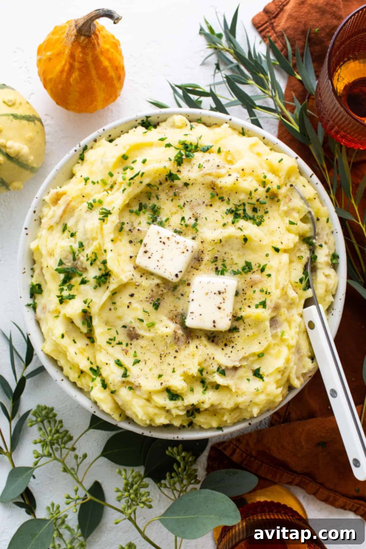 A bowl of mashed potatoes with feta cheese garnish, showcasing a creamy texture.