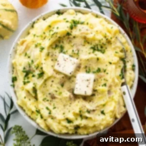 A bowl of mashed potatoes with feta cheese, beautifully garnished and ready to serve.