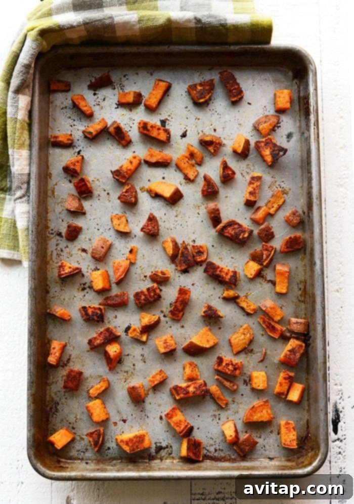 Roasted sweet potatoes are the most delicious vegetable addition to any meal. In this post, we're teaching you how to roast sweet potatoes perfectly every time. sweet potato cubes on pan