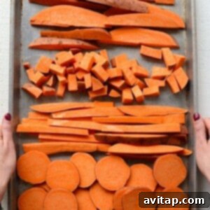 Sweet potatoes cut into a variety of shapes on a baking sheet.