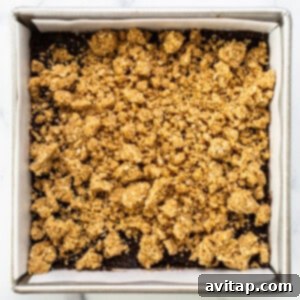 Sun-Kissed Fig & Oat Crumble Squares 12 The baking pan layered with the oat crust, fig filling, and a generous sprinkle of oat crumble topping.