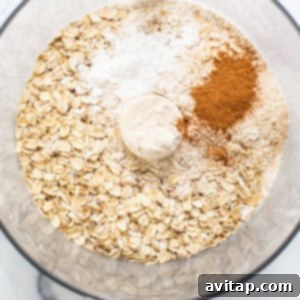 Sun-Kissed Fig & Oat Crumble Squares 9 Dry ingredients for the oat crumble, including rolled oats, flour, and cinnamon, in a mixing bowl.