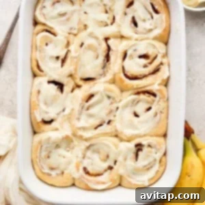 Cinnamon rolls in a baking dish with bananas.