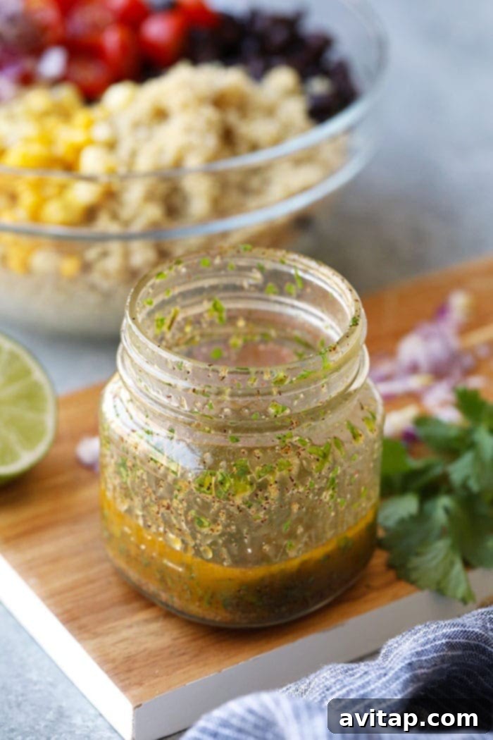 Homemade lime vinaigrette dressing prepared in a mason jar, ready to be shaken and poured over the salad.