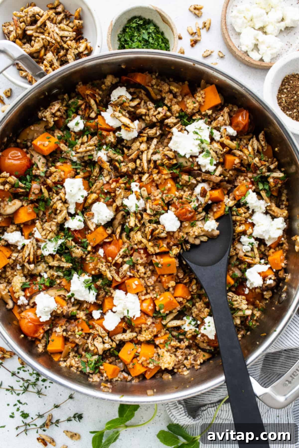 A skillet filled with vegetables and feta cheese.