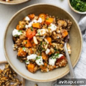 A bowl of quinoa and squash with feta and nuts.
