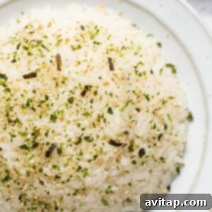 Sticky Rice Magic in the Instant Pot 11 White rice on a plate with herbs and spices.