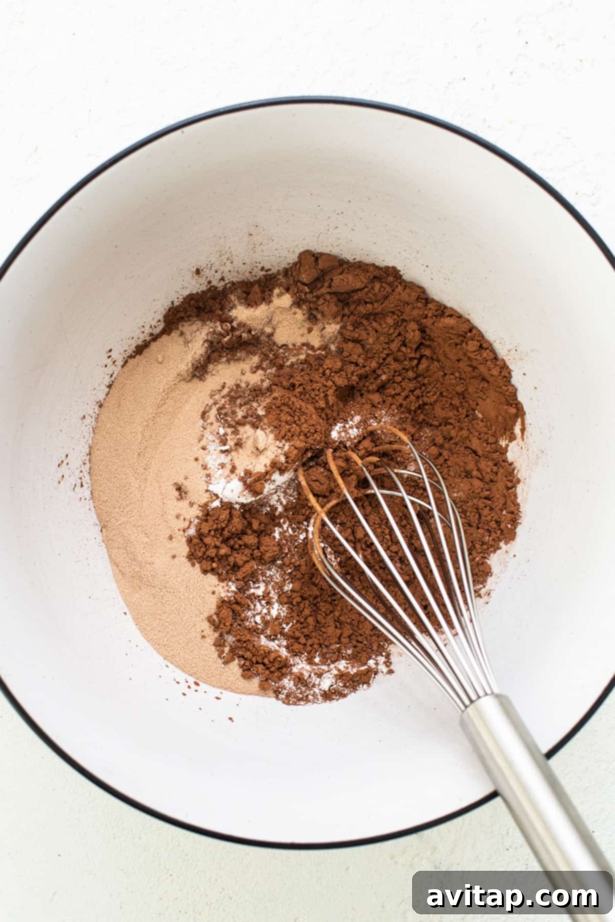 Peanut Butter Protein Power Brownies 4 A bowl with cocoa powder and a whisk.