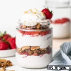 Strawberry granola parfait in a mason jar.