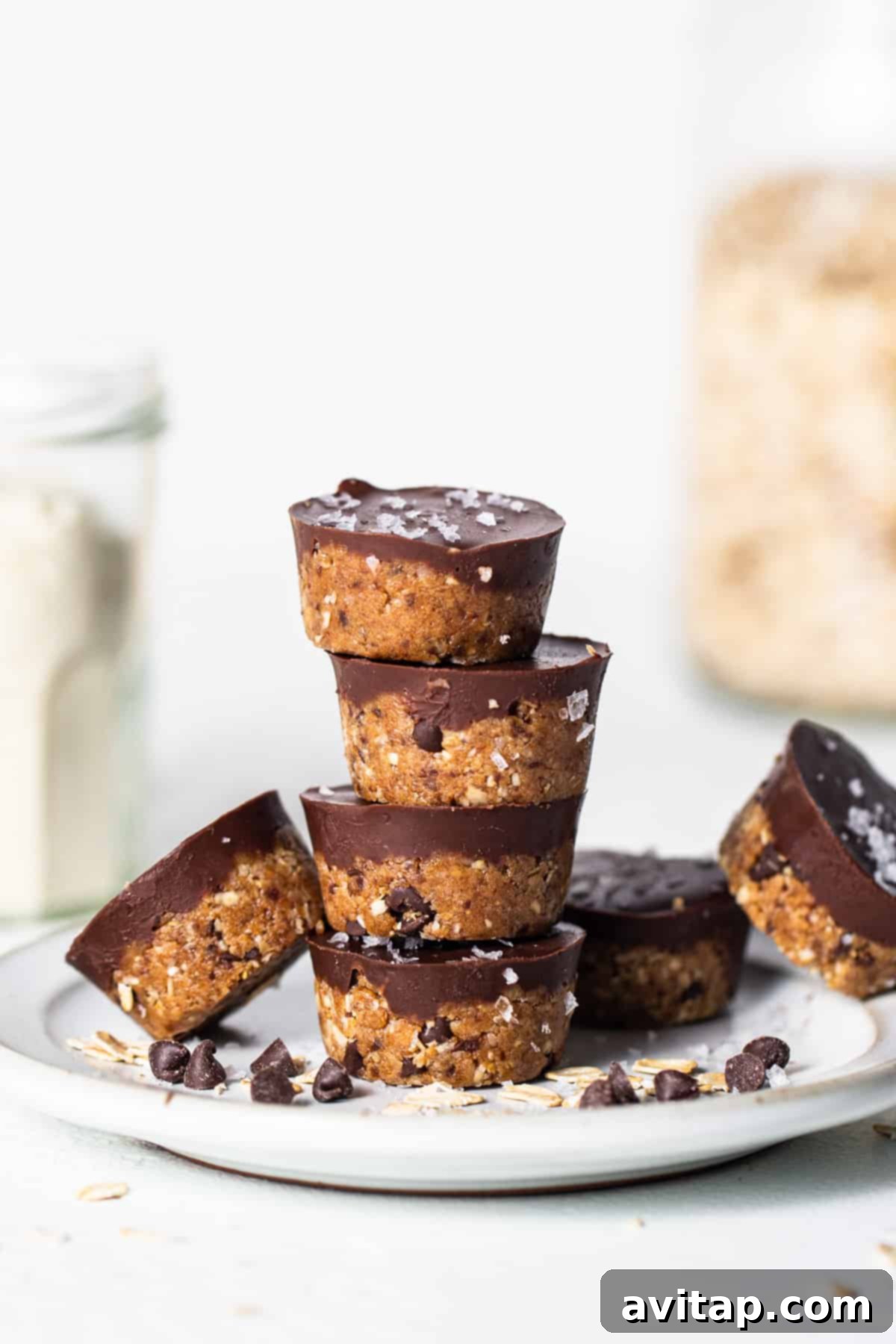A stack of chocolate oatmeal cups on a plate, showcasing their inviting texture and rich chocolate topping.