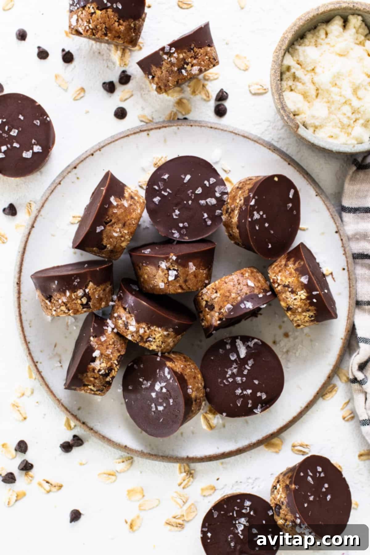A plate topped with chocolate covered granola bars, similar in concept to the protein cookie dough cups, emphasizing healthy, sweet treats.