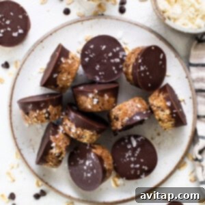 A plate topped with chocolate covered granola bars, representing the final delicious, set protein cookie dough cups ready for storage or consumption.