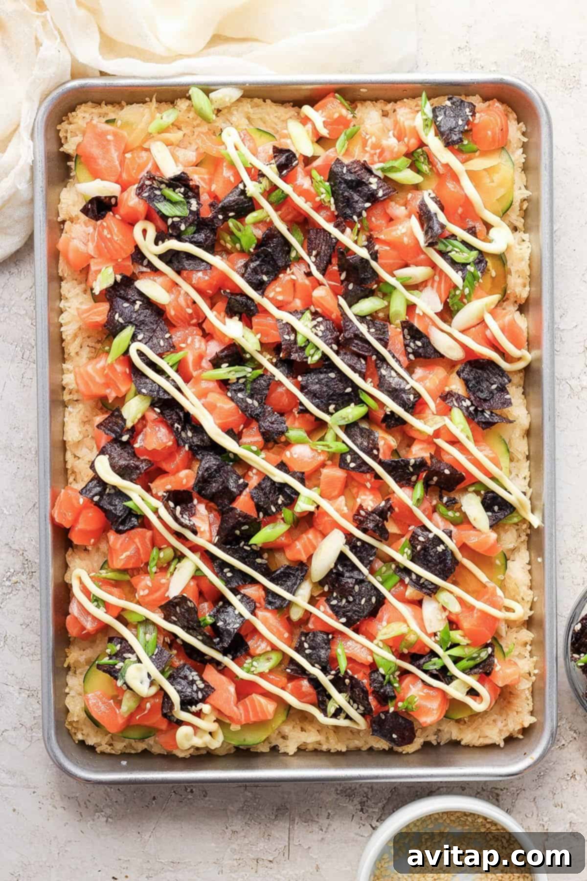A beautifully plated serving of sheet pan crispy rice and salmon, showcasing individual portions.