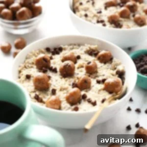 A bowl of Chocolate Chip Cookie Dough Oatmeal accompanied by a cup of coffee on a wooden table.