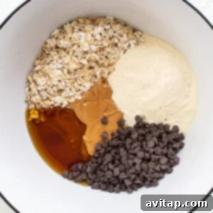 A bowl with ingredients for a chocolate chip cookie, before mixing.