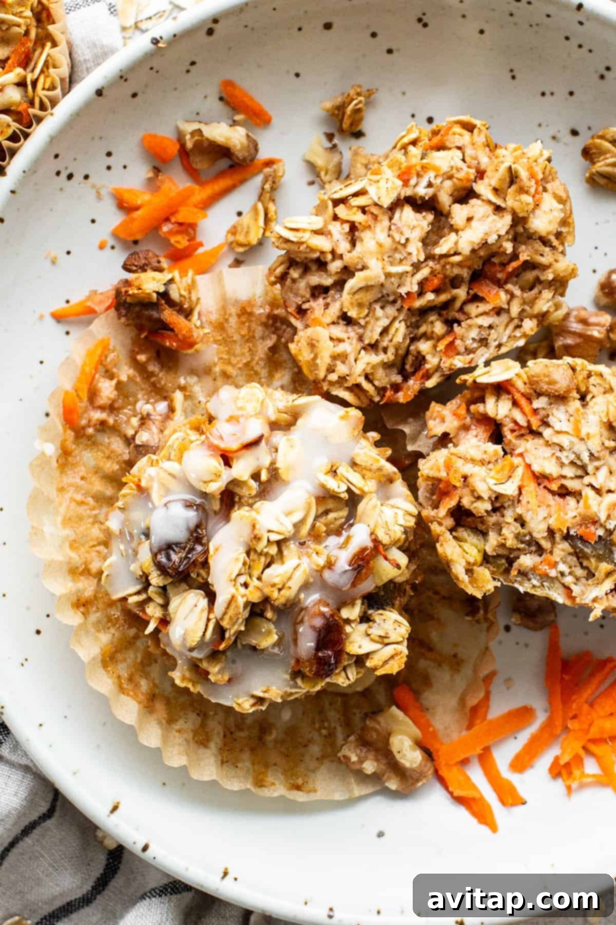 Spiced Carrot Cake Oatmeal Cups 2 A plate with granola muffins on it.