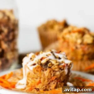 Spiced Carrot Cake Oatmeal Cups 10 Carrot muffins on a plate with a jar of granola.
