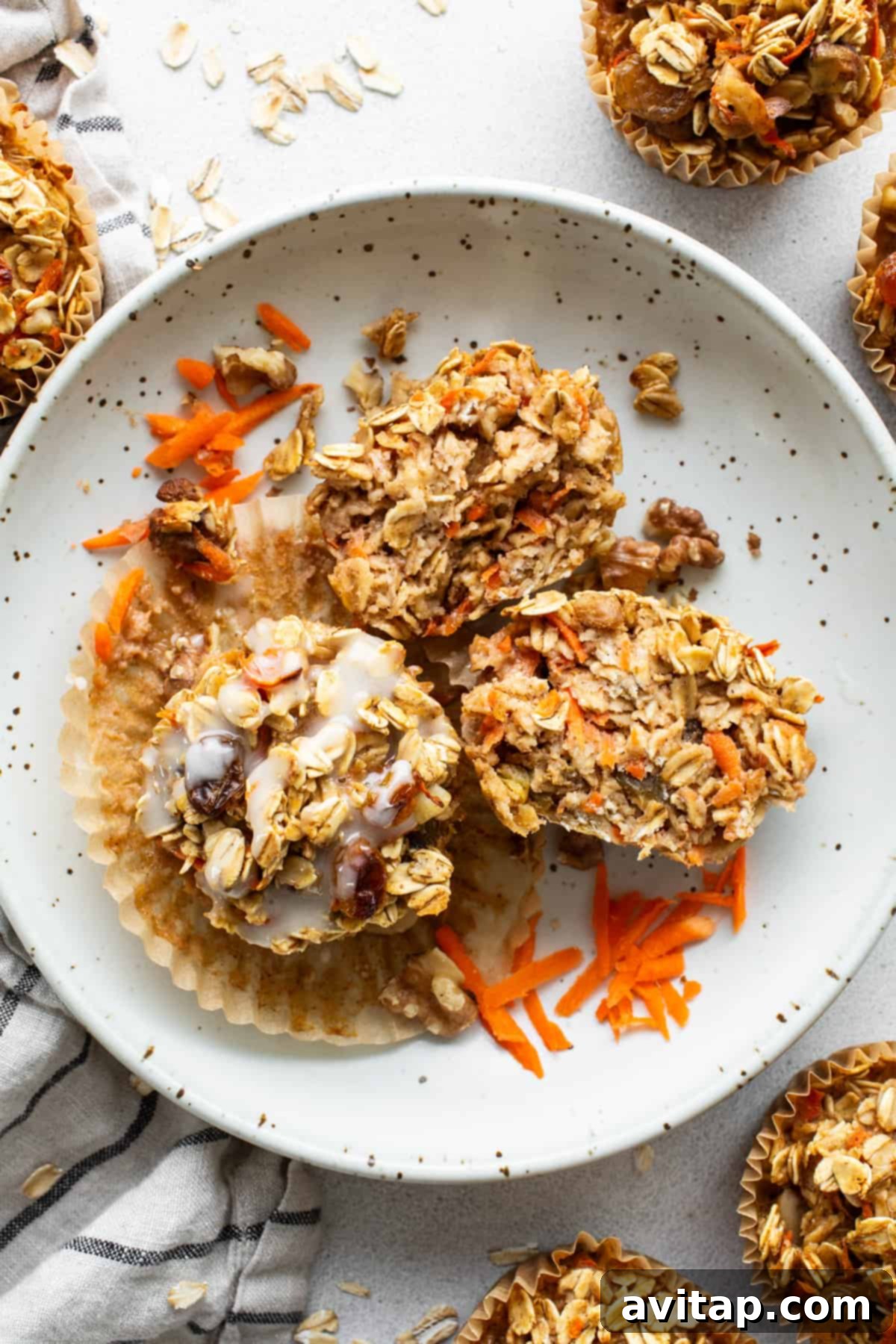 Spiced Carrot Cake Oatmeal Cups 6 Carrot granola muffins on a plate.