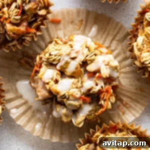A group of muffins with granola and carrots.