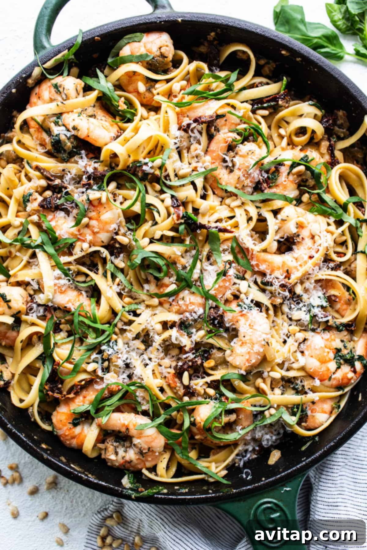 A skillet filled with pasta and shrimp.