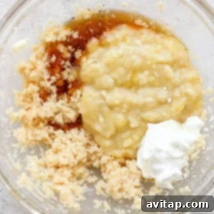 Banana Bread Ring Treats 10 Ingredients combined in a glass bowl, possibly for baking, including mashed bananas, sugars, and a dollop of sour cream or yogurt.