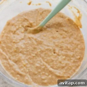 Banana Bread Ring Treats 11 A bowl of thick, mixed batter with a green silicone spatula.