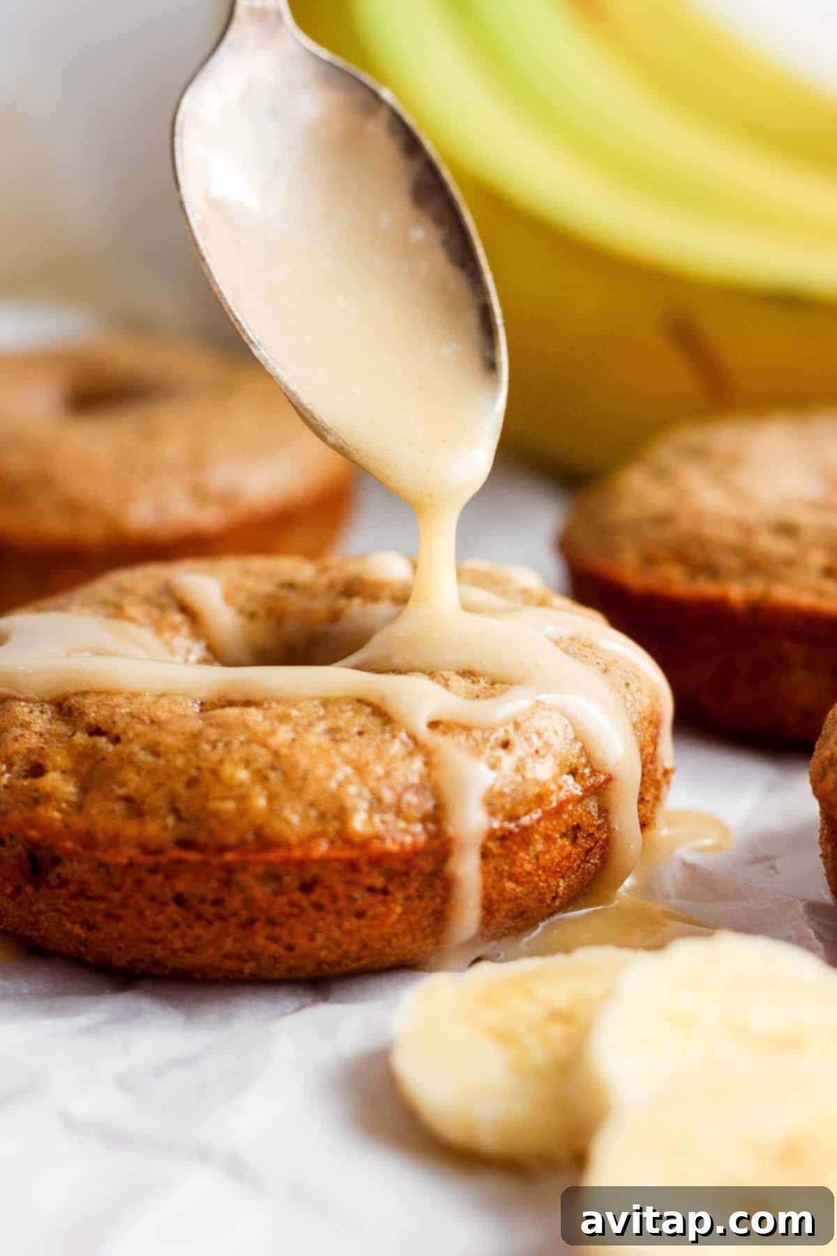 Banana Bread Ring Treats 6 Drizzling icing onto freshly baked banana muffins.
