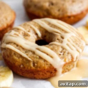 Banana Bread Ring Treats 8 A banana-flavored donut with a glaze topping on a white background.