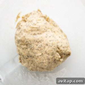 A ball of dough in a glass bowl.