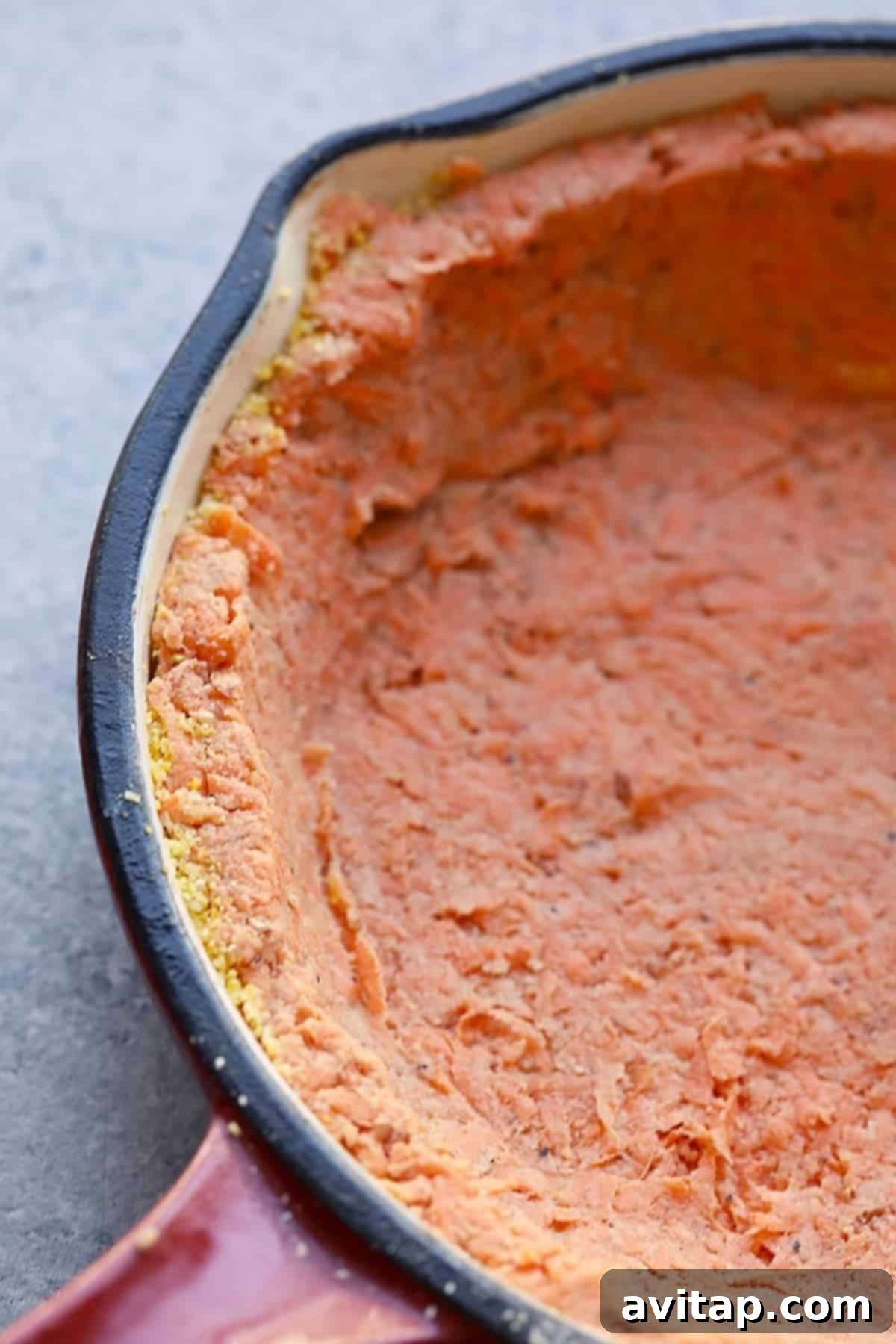 The March Wellness Culinary Club 3 A savory sweet potato pie, rich and golden-brown, baked to perfection in a rustic cast-iron skillet, showcasing the delicious texture of the crust and filling. This healthy quiche recipe is perfect for breakfast, brunch, or a light dinner.