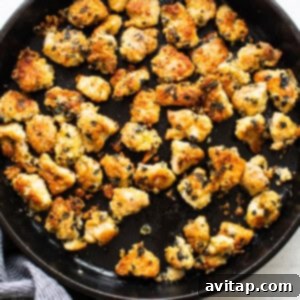 Pan-searing crispy nori-coated chicken pieces in a hot skillet until golden brown and cooked through, ready for the ramen noodle salad.