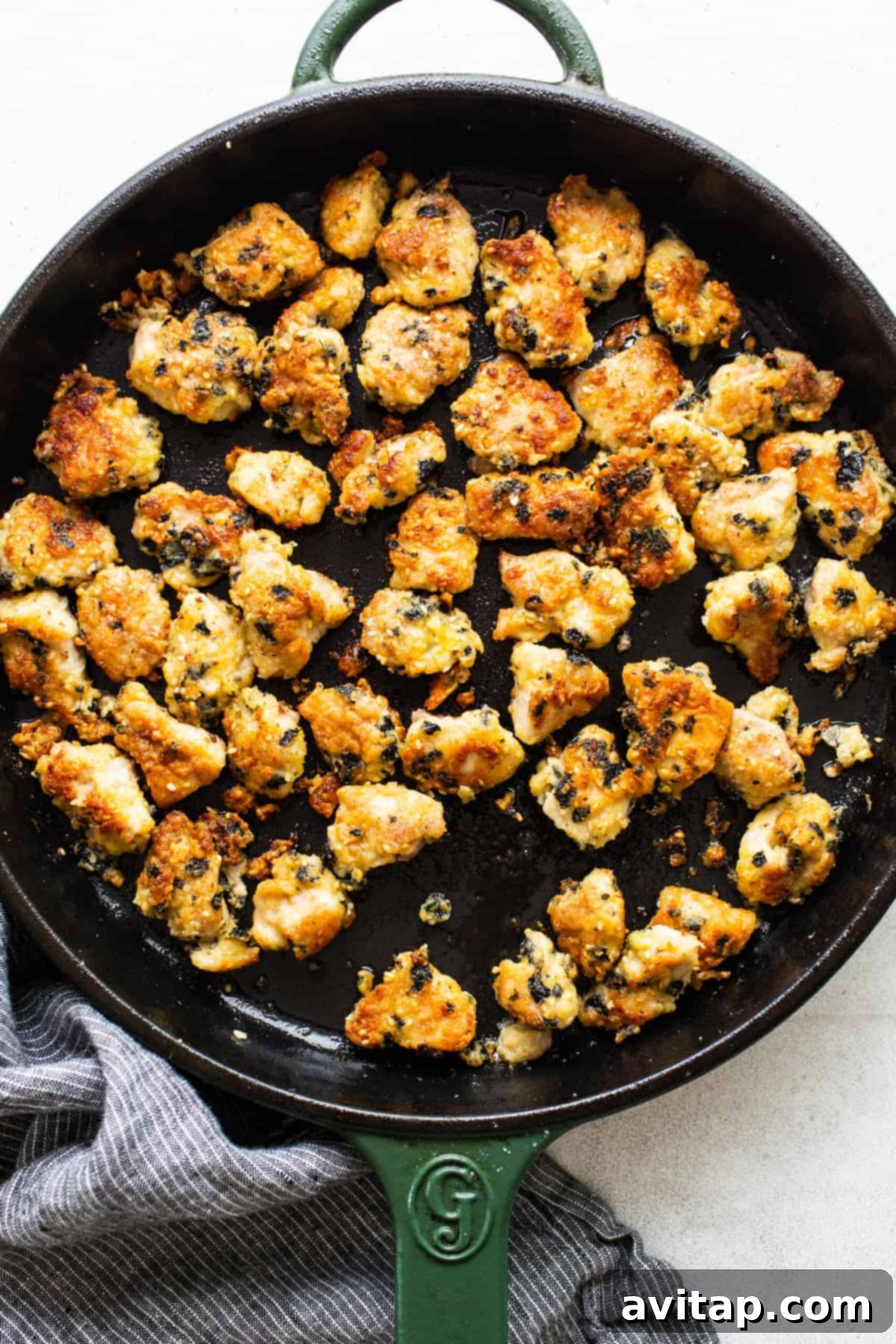 Chicken pieces being pan-seared to a golden brown in a hot skillet, creating a delicious crispy exterior.