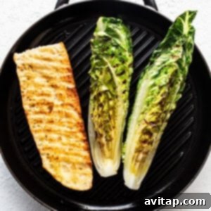 Flame-Kissed Caesar with Crispy Charred Croutons 10 Grilled fish fillet and halves of romaine lettuce on a stove-top grill pan, showing appealing char.