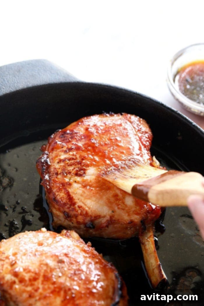 pork chops in cast iron skillet, seared to perfection