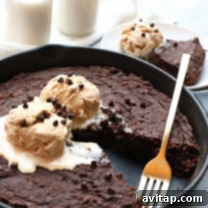 A skillet dessert with chocolate chip brownies and ice cream, reminiscent of sweet potato brownies.