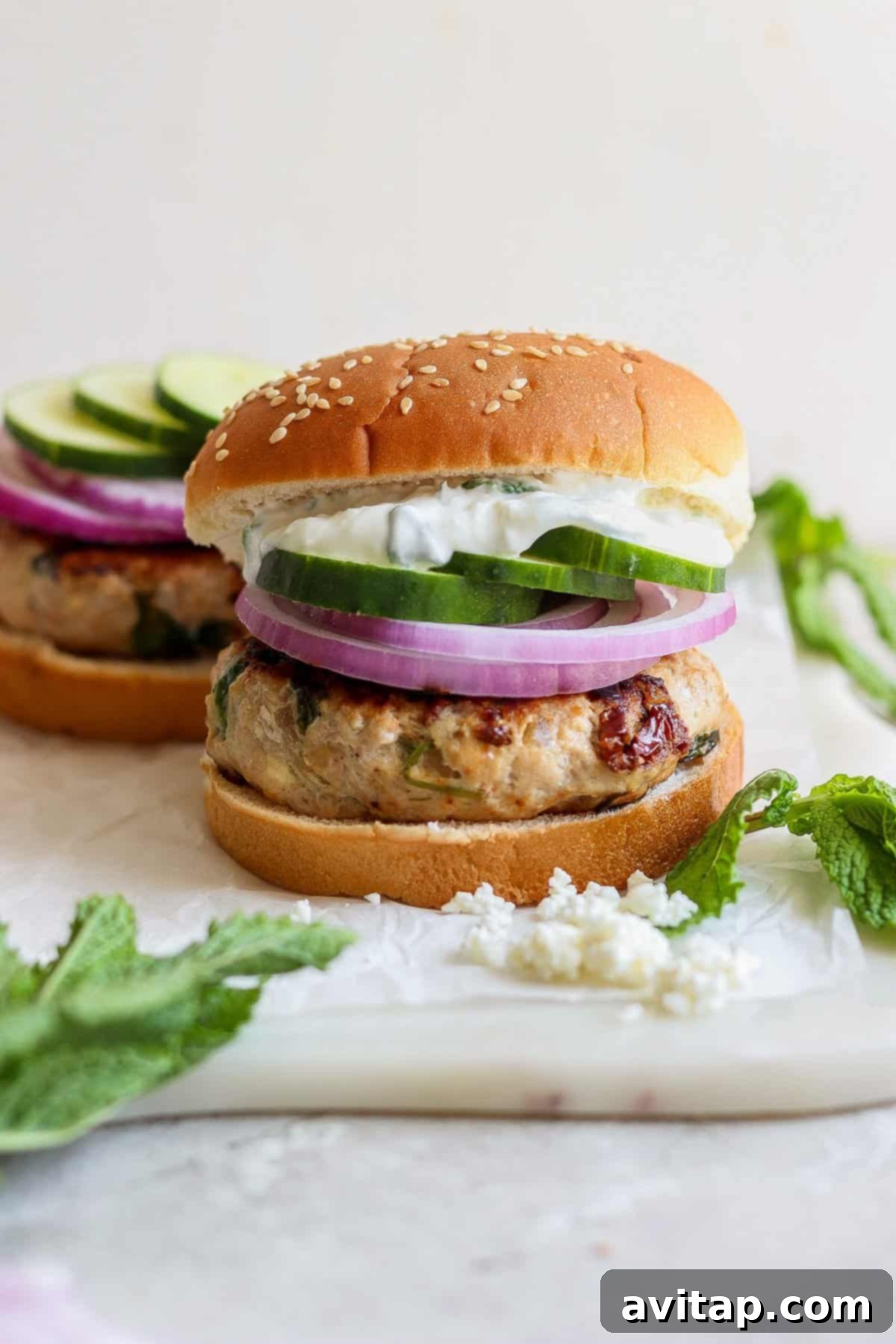 A container of leftover Mediterranean burger patties in the refrigerator.