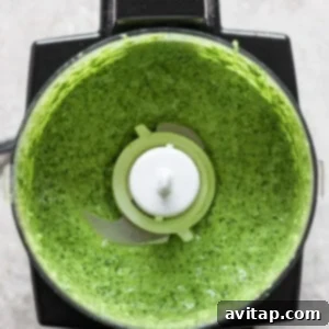 Effortless Air Fryer Steak Bites 10 A top-down view of a blender with green sauce inside, featuring visible greens and herbs blended to a smooth consistency.