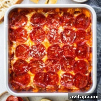 A square pan of delicious pepperoni pizza, featuring a golden, crispy crust, generously melted cheese, and perfectly sliced pepperoni, adorned with a final sprinkle of grated cheese, surrounded by fresh bread slices and a striped napkin.